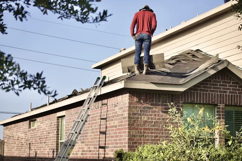 Professional roofer working on a residential roof in The Courtyards